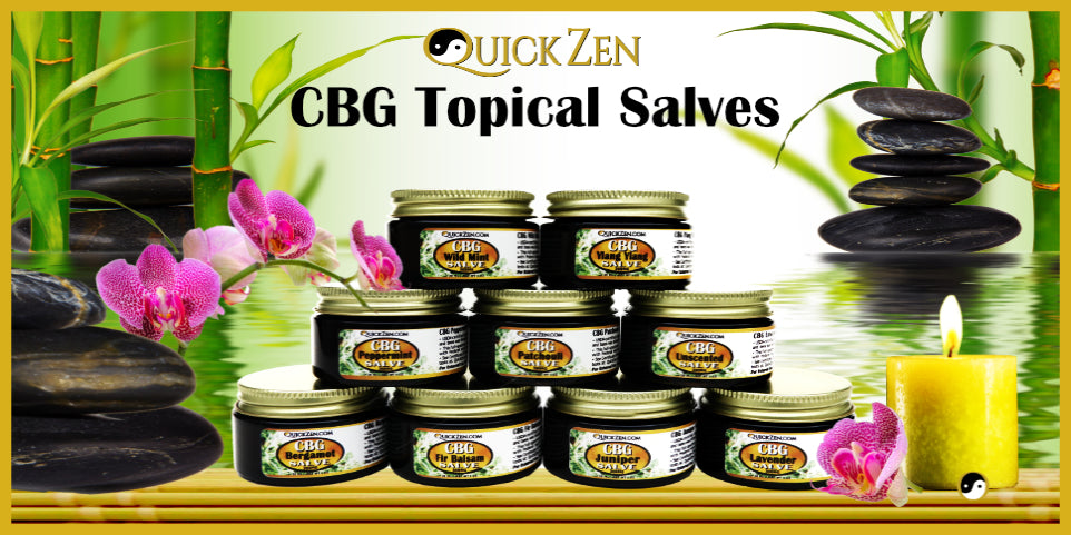 QuickZen CBG Salves Collection. Displayed in a pyramid. A yellow candle, pink orchids, black rocks and green bamboo..
